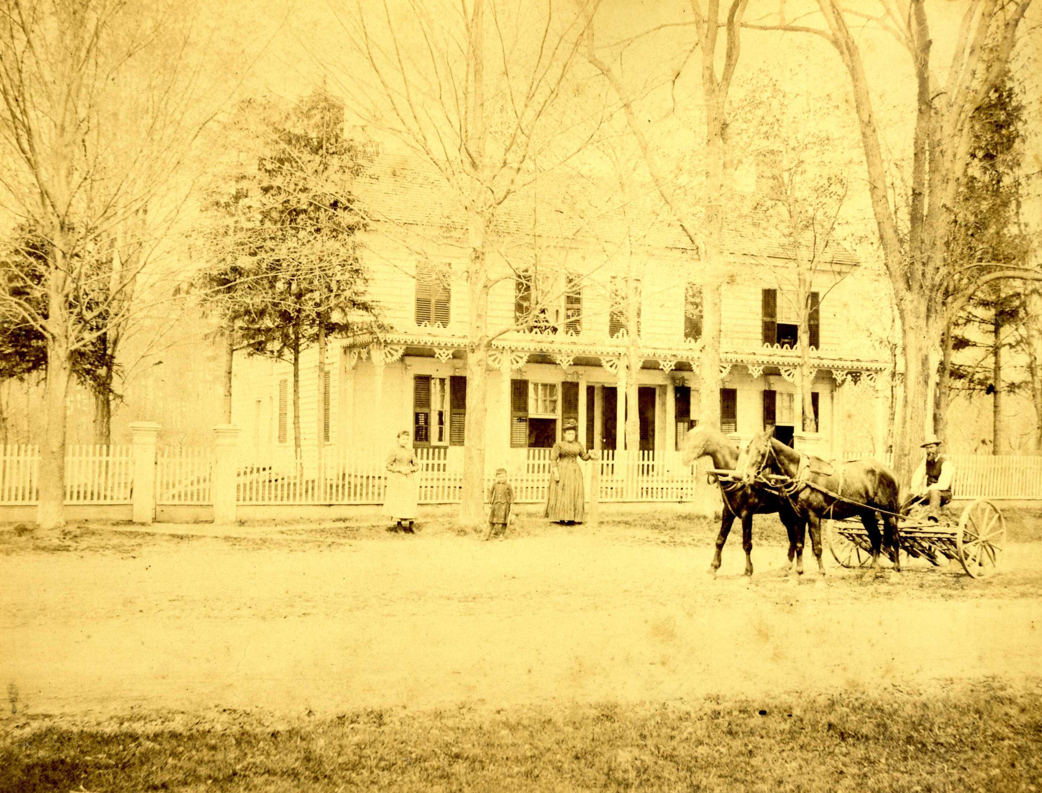 The New Concord b&b in a photo from the 1800's with two horses and a buggy