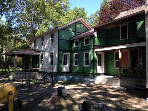 Siding gong on, porches in place